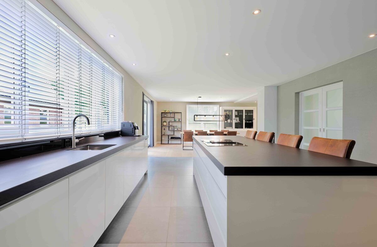 Plameco spanplafond: moderne witte keuken met achter het plafond verborgen geluidsabsorberend materiaal